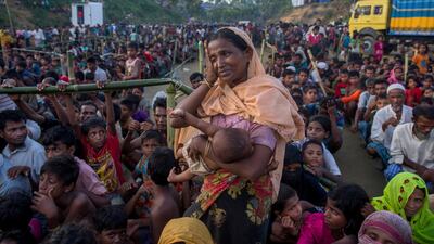 A Rohingya Muslim woman waits to receive aid during its distribution near Balukhali refugee camp, Bangladesh. Dar Yasin / AP Photo