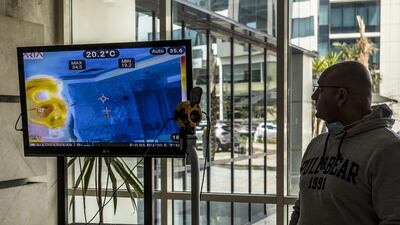A thermal imaging camera shows the body temperature of a visitor at a company in Cairo. AFP