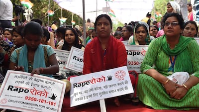 Indian women hold placards as they sit during a protest organised by Delhi Commission for Women in New Delhi, India, on April 13, 2018. Money Sharma / AFP