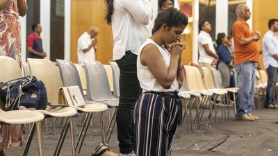 A worshipper in silent contemplation at the memorial service. Antonie Robertson / The National