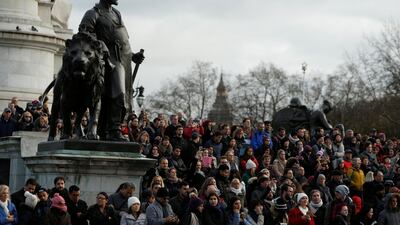 Tourists stand outside Buckingham Palace after Prince Harry announced his engagement to Meghan Markle, in London. Darrin Zammit Lupi / Reuters