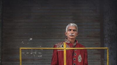 Suresh Singh, 60, from Moradabad, a member of Master Band specializing in playing weddings, poses for a portrait in New Delhi.