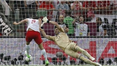 Poland’s Robert Lewandowski, left, scored the first of 20, so far, headed goals in Euro 2012.