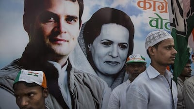 Supporters of the Congress Party stand in front of a poster showing Rahul Gandhi and his mother and party president Sonia Gandhi. Kevin Frayer/Getty Images