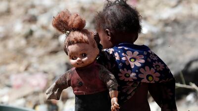 A displaced Yemeni child holds a doll at a camp for Internally Displaced Persons (IDPs) on the outskirts of Sanaa. EPA