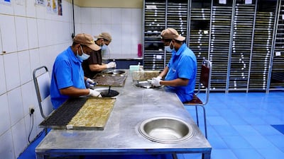 Workers at the factory in Sharjah hand roll bakhoor.
