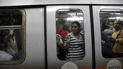 People ride a car at the Ataba metro station, in Cairo, Egypt.
