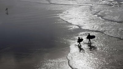 Surfers leave the water after a surf session during an unusually warm winter day on Biarritz beach, southwestern France, as unseasonably warm temperatures reached 22 degrees Celsius. Regis Duvignau / Reuters
