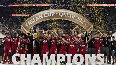 Qatar's players celebrate on the podium after their 3-1 victory against Jordan in the AFC Asian Cup final at Lusail Stadium. EPA