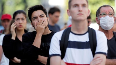 A crowd gathers at the scene of a fire at the cathedral. Reuters