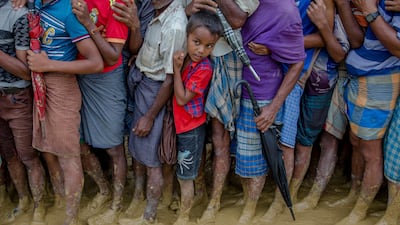 Rohingya Muslims line up and wait to collect food aid near Kutupalong refugee camp in Bangladesh (AP Photo/Dar Yasin)