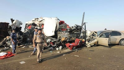 Omani police inspect the site of a collision between alorry and a bus in western Oman on March 1, 2016 that killed 18 people. Oman Police / AFP