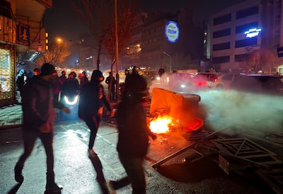 Fires are lit as protesters rally in Tehran last week. The demonstrations began last month due to soaring inflation and the collapse of the rial. Getty Images