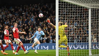 John Stones heads City's second goal past Arsenal goalkeeper Aaron Ramsdale. AFP