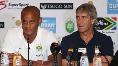 Manchester City manager Manuel Pellegrini, right, and Vincent Kompany in South Africa. Steve Haag / Getty Images