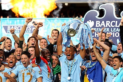 Vincent Kompany, the Manchester City captain, lifts the Premier League trophy to end the club's 44-year wait to once again be champions of England following their dramatic 3-2 win against QPR. Getty Images