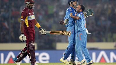 Amit Mishra, right, the India leg-spinner, took two West Indies wickets for just 18 runs in his four-over spell on Sunday. Munir uz Zaman / AFP