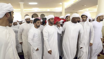 Men carry the body of First Lieutenant Pilot Jassem Saleh Al Zaabi, who died in a helicopter crash in Yemen on Friday. Al Zaabi was laid to rest in his hometown of Ras Al Khaimah on Saturday. Wam