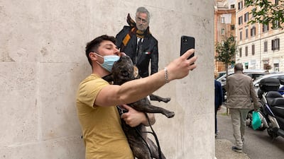 A man takes a picture near a mural depicting Jose Mourinho riding a Vespa scooter adorned with the Roma symbol in the Testaccio neighbourhood of Rome. AP