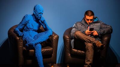 A visitor seats next to the artwork ‘Blu guy seating’ made from 21,682 bricks of LEGO by US artist Nathan Sawaya displayed at the exhibition ‘The Art Of LEGO’ in Moscow, Russia. Sergei Ilnitsky / EPA