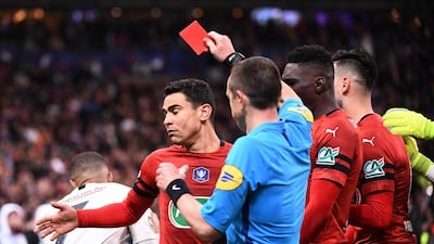 Referee Rudy Buquet is unmoved as he Kylian Mbappe gives a red card. Martin Bureau / AFP