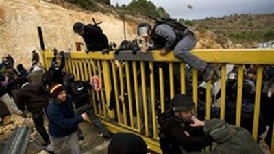 Settlers in Ma'ale Levona, the West Bank, clash with police officers and civil administration officials delivering warrants to freeze construction.
