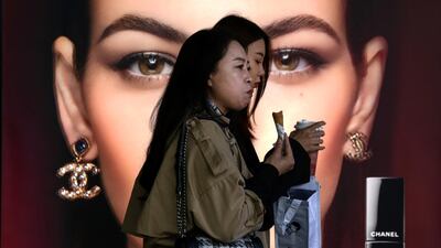 Women walk by a Chanel cosmetic shop at the capital city's popular shopping mall in Beijing. China’s economy grew 2.3% in 2020 as a recovery from the coronavirus pandemic accelerated while the US, Europe and Japan struggled with disease flare-ups. AP