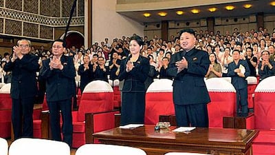South Korean media are speculating who is the woman standing to the left of Kim Jong-un, the new North Korean leader.