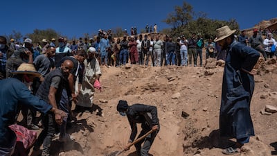 Mourners watch as a grave is dug for a man killed by the earthquake, in Douzrou, Morocco. Getty Images