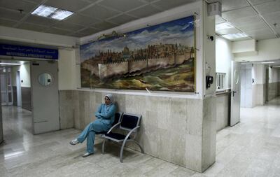 A nurse sits outside the obstetrics and gynaecology ward at Makassed Hospital in East Jerusalem, which is facing a financial crunch caused by a drop in patients as a result of the coronavirus outbreak. AFP