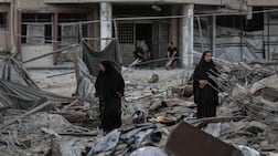 Palestinians among the rubble from an Israeli air strike in Gaza city. Bloomberg