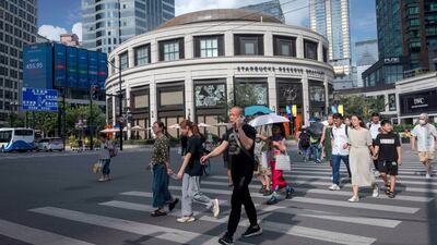 Pedestrians in central Shanghai. China's central bank has cut key policy rates for the second time since June in a bid to revive sagging economic growth. EPA