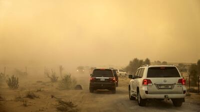 People drive through heavy rain on the outskirts of Dubai. AFP