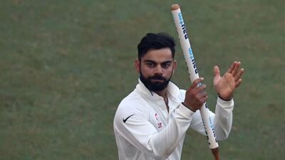 India captain Virat Kohli applauds the crowd as he leads his team on a victory lap of the ground after India won the fourth Test match against England at the Wankhede stadium in Mumbai on December 12, 2016. Indranil Mukherjee / AFP