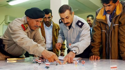 Iraqi military officers discuss security operations over a 'wargaming' table at Iraq's Permanent Joint Operations Centre in Basra. AFP