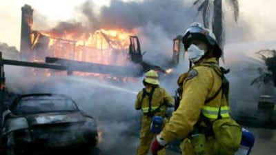 Firefighters battle a blaze on Nov 15 2008 in Yorba Linda, California. Strong Santa Ana winds are fanning flames throughout Southern California, destroying hundreds of homes and causing thousands to evacuate.