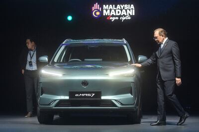 Malaysian Prime Minister Anwar Ibrahim inspects the first locally produced electric vehicle, the e MAS 7, at its launch in Kuala Lumpur last month. AFP