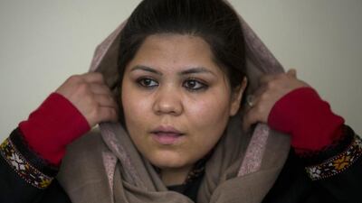 In this Wednesday, March 5, 2014 photo, prominent Afghan women’s rights activist Wazhma Frogh adjusts her scarf during an interview in her office in Kabul, Afghanistan. A gender and development specialist and human rights activist, Frogh says her experience characterizes the women’s rights movement in her country- after 12 years, billions of dollars and countless words emanating from the West commiserating with Afghan women, the successes are fragile, the changes superficial and vulnerable. (AP Photo/Anja Niedringhaus)