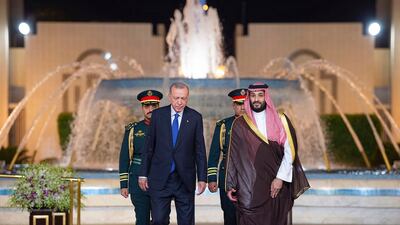 Mr Erdogan and Prince Mohammed walk to a welcome ceremony at Al Salam Palace in Jeddah, Saudi Arabia. AP