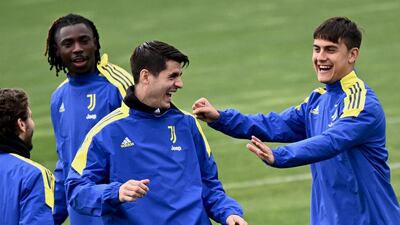 Juventus forwards Alvaro Morata, second left, and Paulo Dybala share a joke during a training session on Tuesday, March 15, 2022, for their Champions League last-16 second leg against Villarreal. AFP