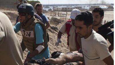 Medical team from Gaza’s Red Crescent and a journalist evacuate one of the boys who was killed by an Israeli naval bombardment in the port of Gaza. Four boys died on the spot during an Israeli naval bombardment in the port of Gaza, a fifth boy died shortly after the attack in hospital. Israel stepped up its attacks on 16 July by bombing the homes of Hamas leaders after the Islamist movement rejected a truce proposal and instead launched dozens more rockets into Israel.