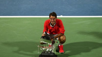 Roger Federer poses with the Dubai trophy after winning his sixth title at last year's tournament. Marwan Naamani / AFP
