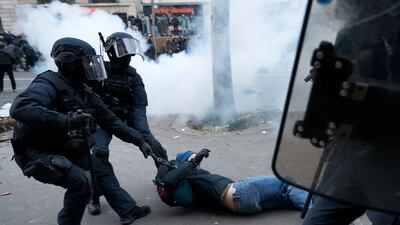 A protester is dragged away by riot police. AP
