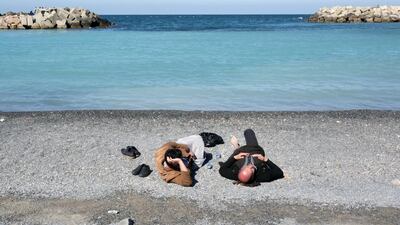 People lay at a beach in Algiers, Algeria. Reuters