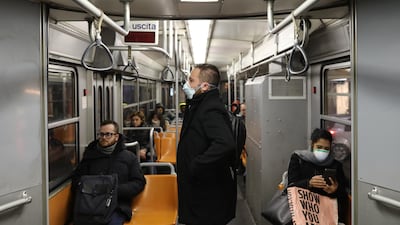 Passengers of the public transport wear a protective mask in Milan, Italy due to coronavirus outbreak. Getty