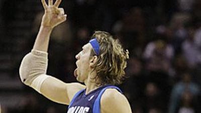 Dirk Nowitzki reacts after making a three-point basket against the San Antonio Spurs.