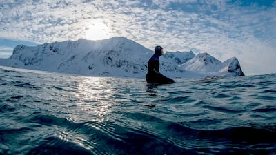 Surf instructor Tommy Olsen teachers beginners how to ride the waves in Norway's Lofoten Island in the Arctic Circle. AFP