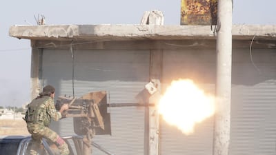 A Turkey-backed Syrian rebel fighter fires a weapon in the town of Tal Abyad, Syria. Reuters