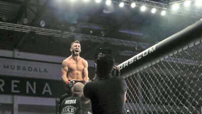 Mohammed Yahya celebrates after defeating Glenn Ranillo in their lightweight bout. Victor Besa/The National