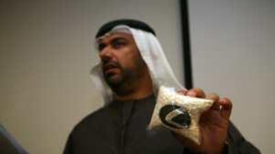Yousef al Adiadi, the director of administration affairs, holds a bag of Captagon pills during a press conference in Dubai.